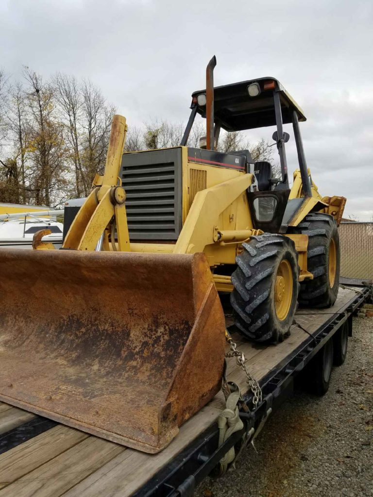 Cat 416 Backhoe on a trailer for transport. 