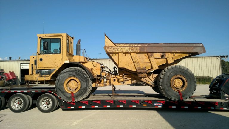 CAT D25 Articulated Dump Truck Shipped on a Lowboy Trailer.