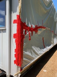 Tarp Repairs Tarp fully repaired with red tape.