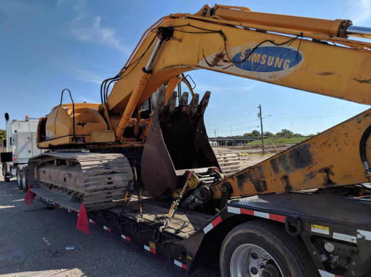 Transporting a Samsung Excavator on a trailer.