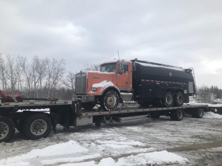 Kenworth Heavy Duty Truck transported on an RGN in snow.