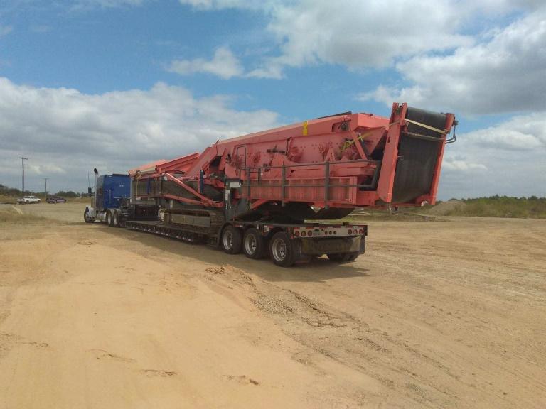 terraine5 Rough terrain crane being driven off on an RGN trailer