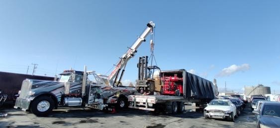 Loading a forklift onto a Conestoga trailer