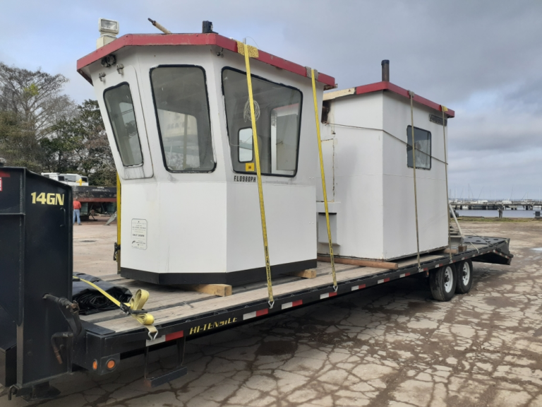 Hauling a tugboat on a trailer.