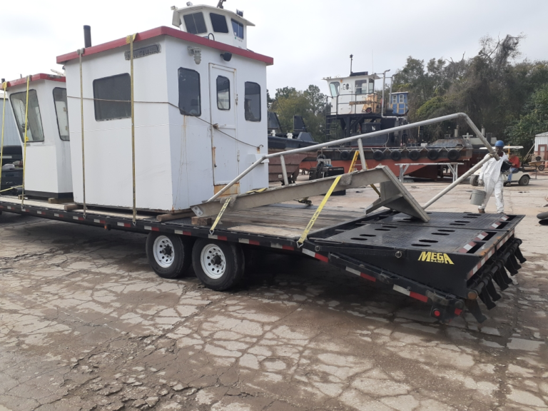 Hauling a tugboat on a trailer.