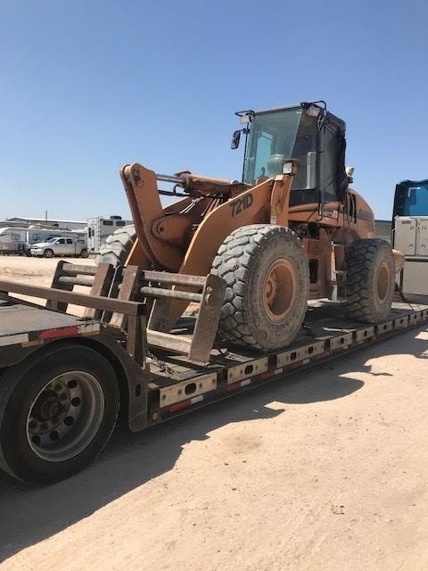 Tractor on a trailer for transport.