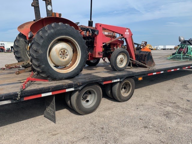 Massey Ferguson on a trailer for transport.