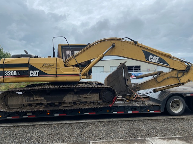 Cat Excavator transported on a trailer.