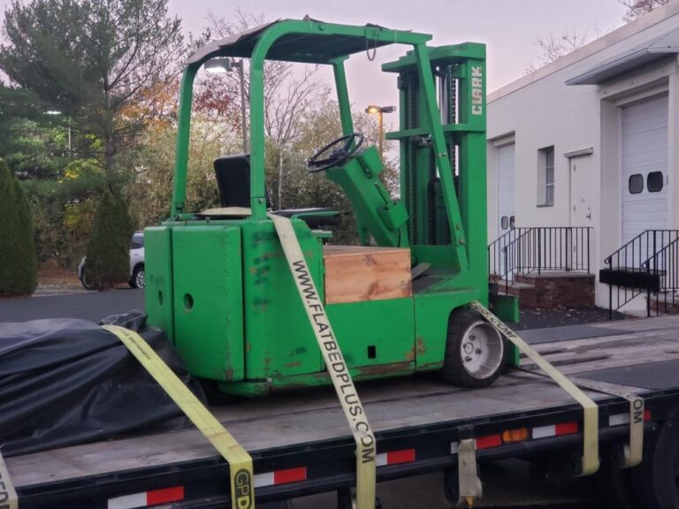 Strap securing Forklift on Trailer for Transport.