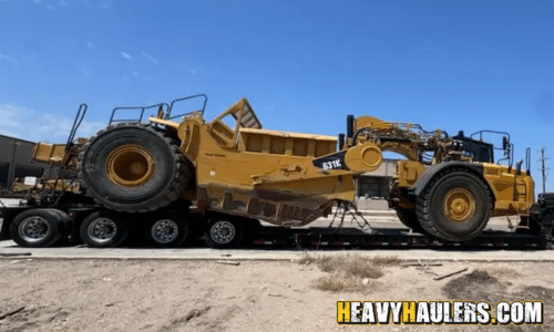 Transporting a CAT 631K Scraper on a lowboy trailer.