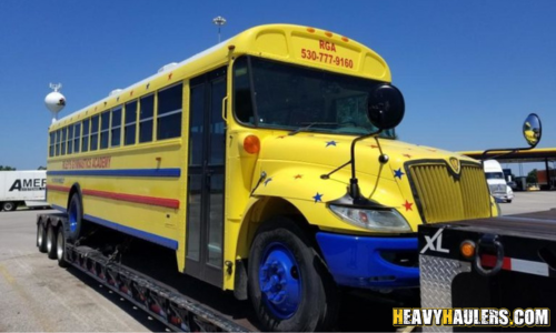 Transporting a 2018 Blue Bird Vision school bus on a extended double drop deck trailer.