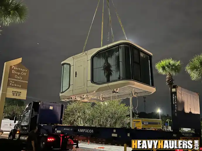 A crane lifting a container home.