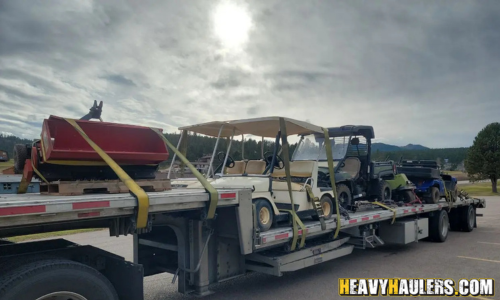 Shipping multiple golf carts on a step deck trailer.