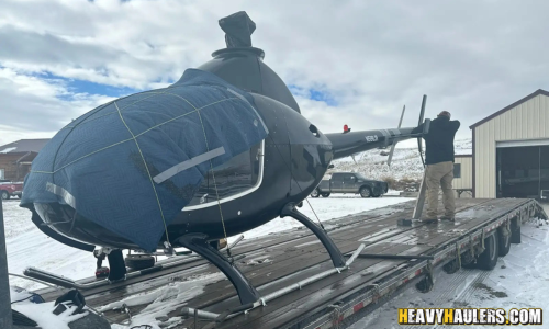 Shipping a helicopter on a flatbed trailer.