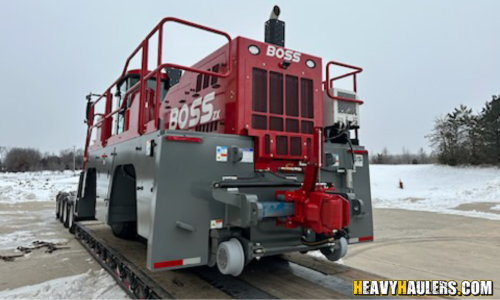 Shipping a Boss rail car on a lowboy trailer.