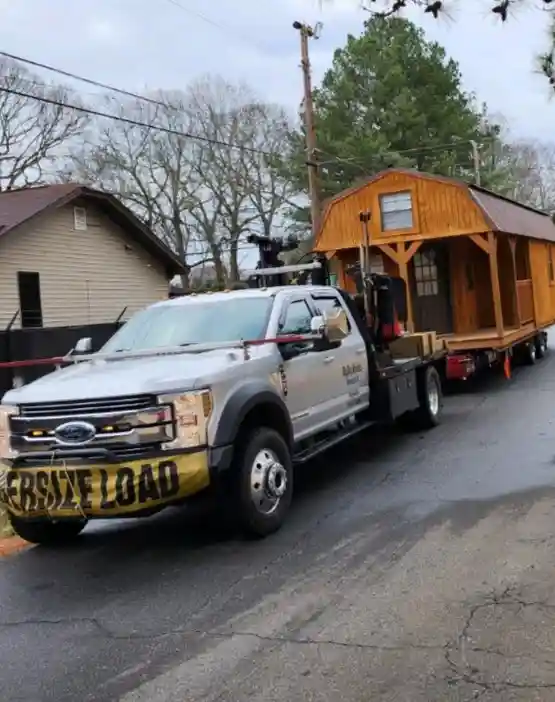 tan shed being moved