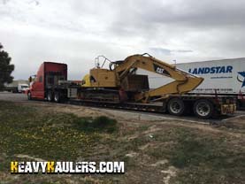 Hauling Caterpillar 321C Hydraulic Excavator