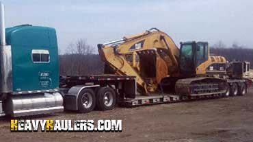 Hauling Caterpillar 325CL Hydraulic Excavator